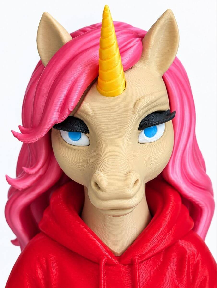 Detailed unicorn figure head with pink hair and a gold horn