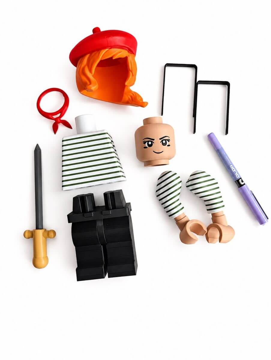 Separate 3D-printed parts for an assembly figure including head, hair, clothing, and accessories