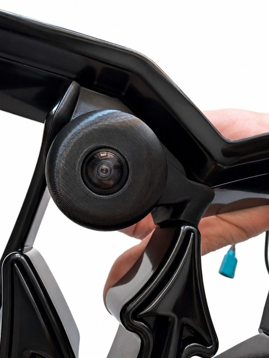 3D-printed 360-degree camera housing mounted on the front bumper of a Maserati Ghibli and held in hand