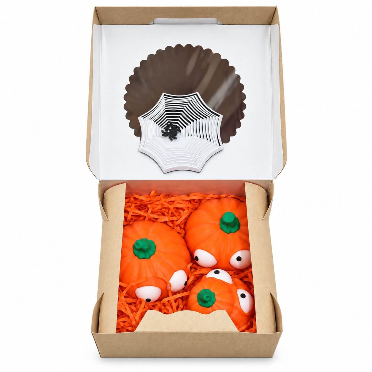 Kraft gift box with spiderweb decoration and pumpkin figures in orange shredded paper