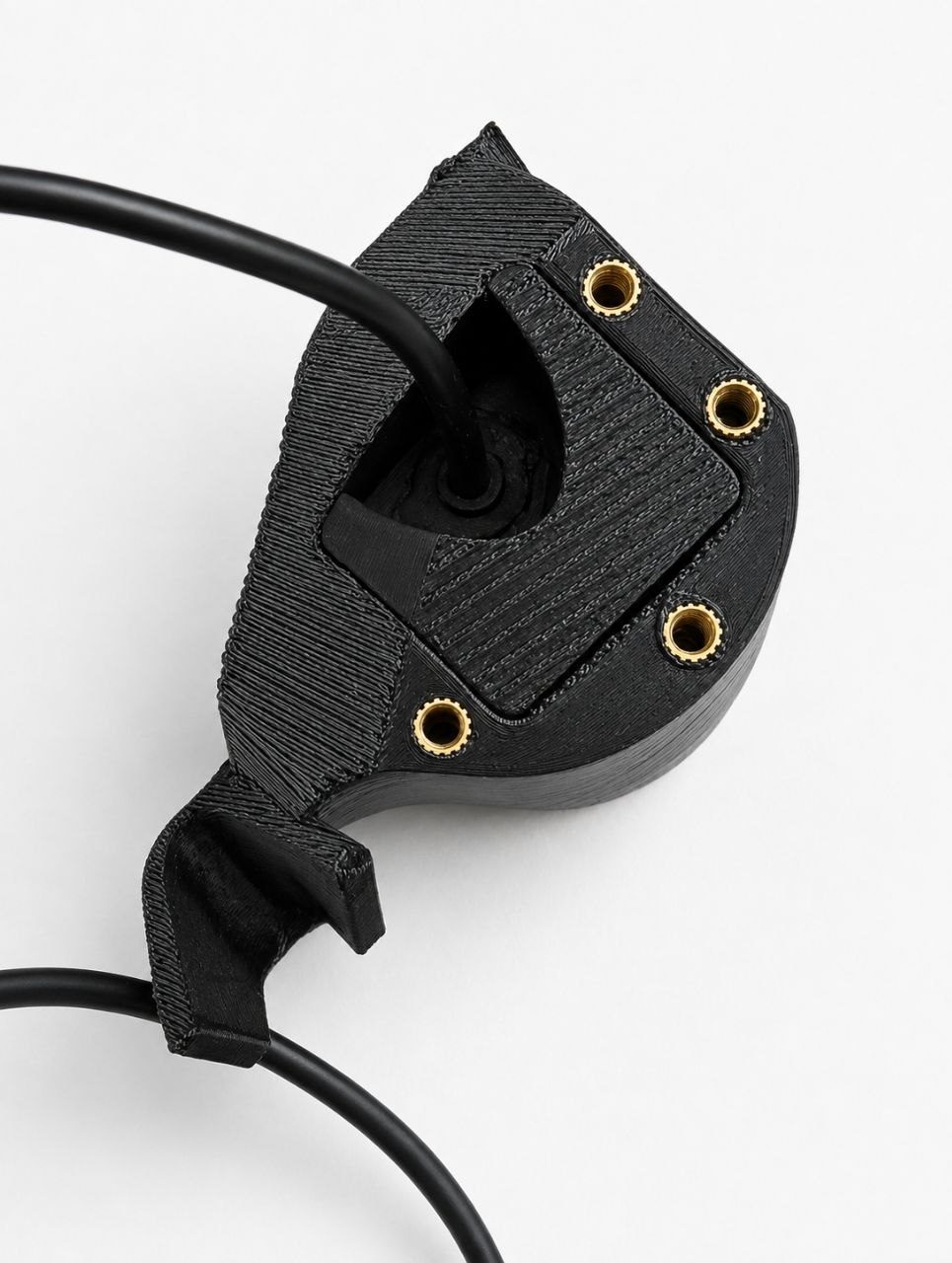 Black 3D-printed enclosure with four brass threaded inserts and a cable opening
