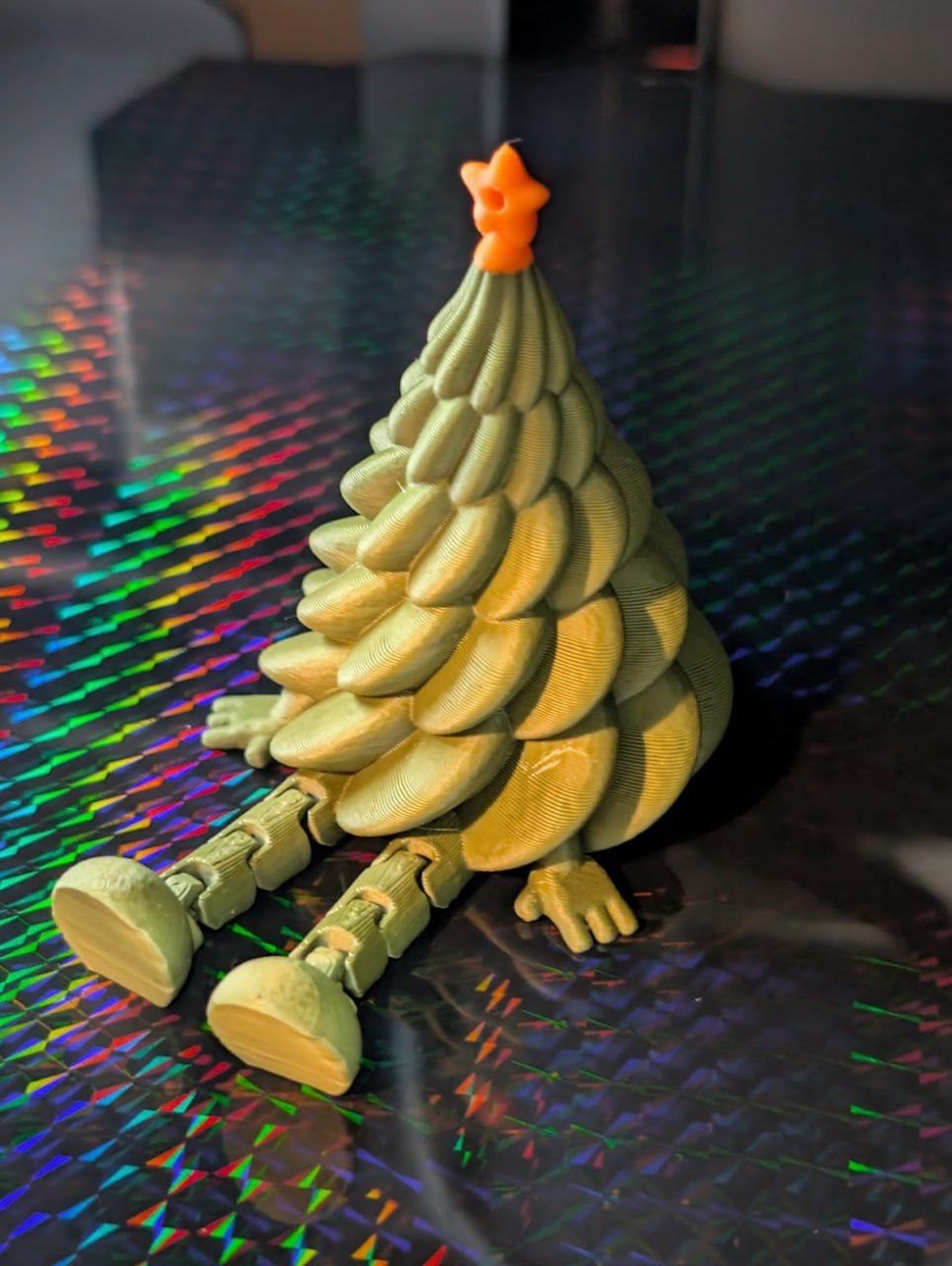 Christmas tree character with legs and an orange star, printed as a decorative figure