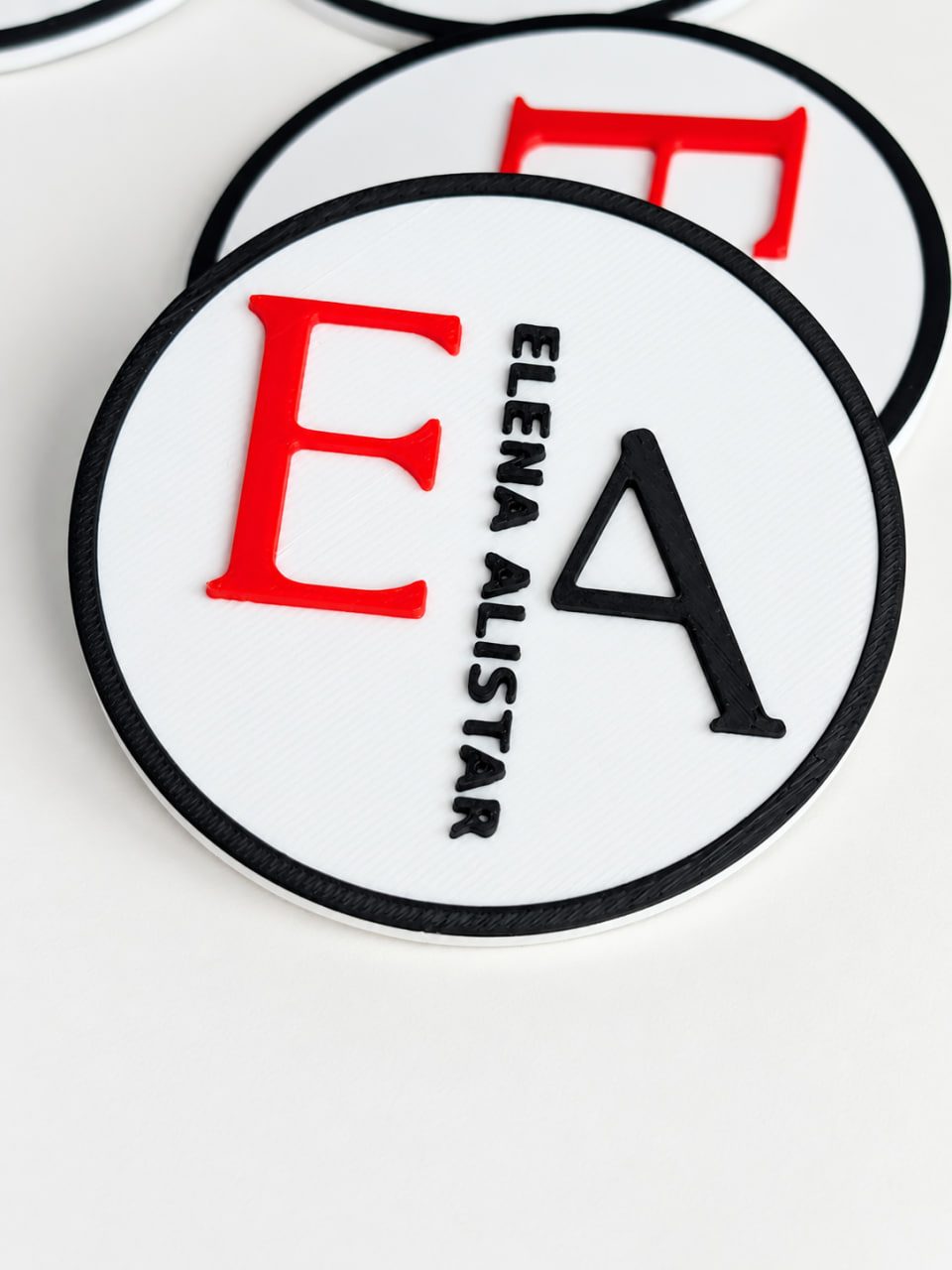 3D-printed personalized stands with the initials EA