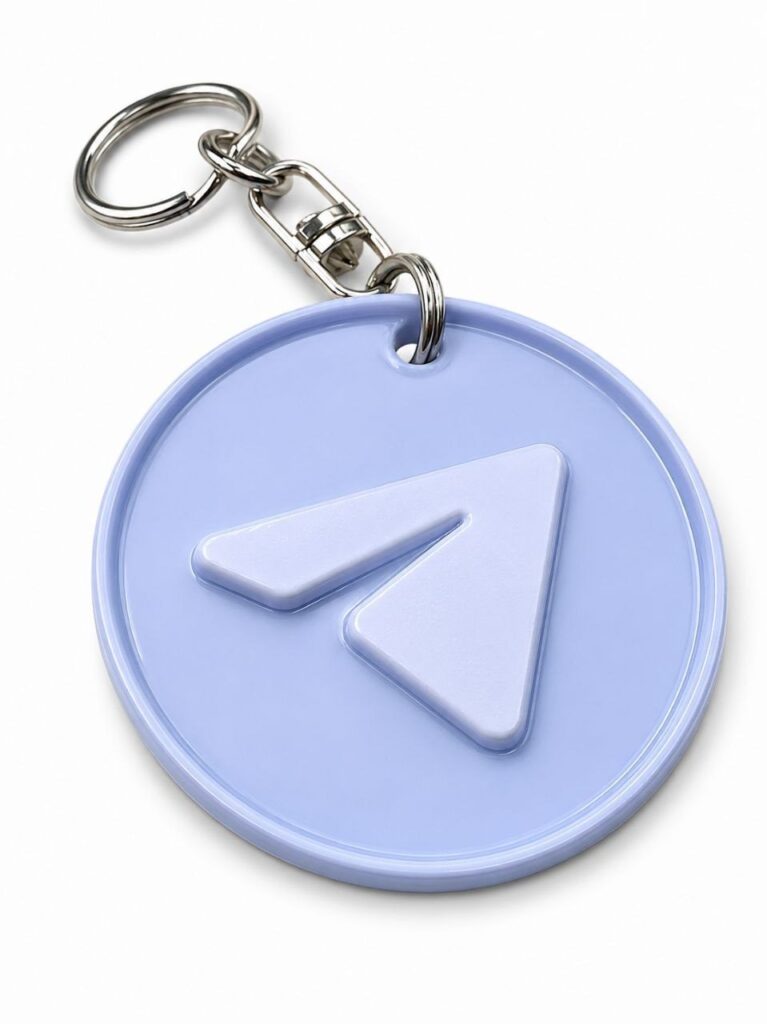Round blue NFC keychain with an integrated chip and Telegram logo