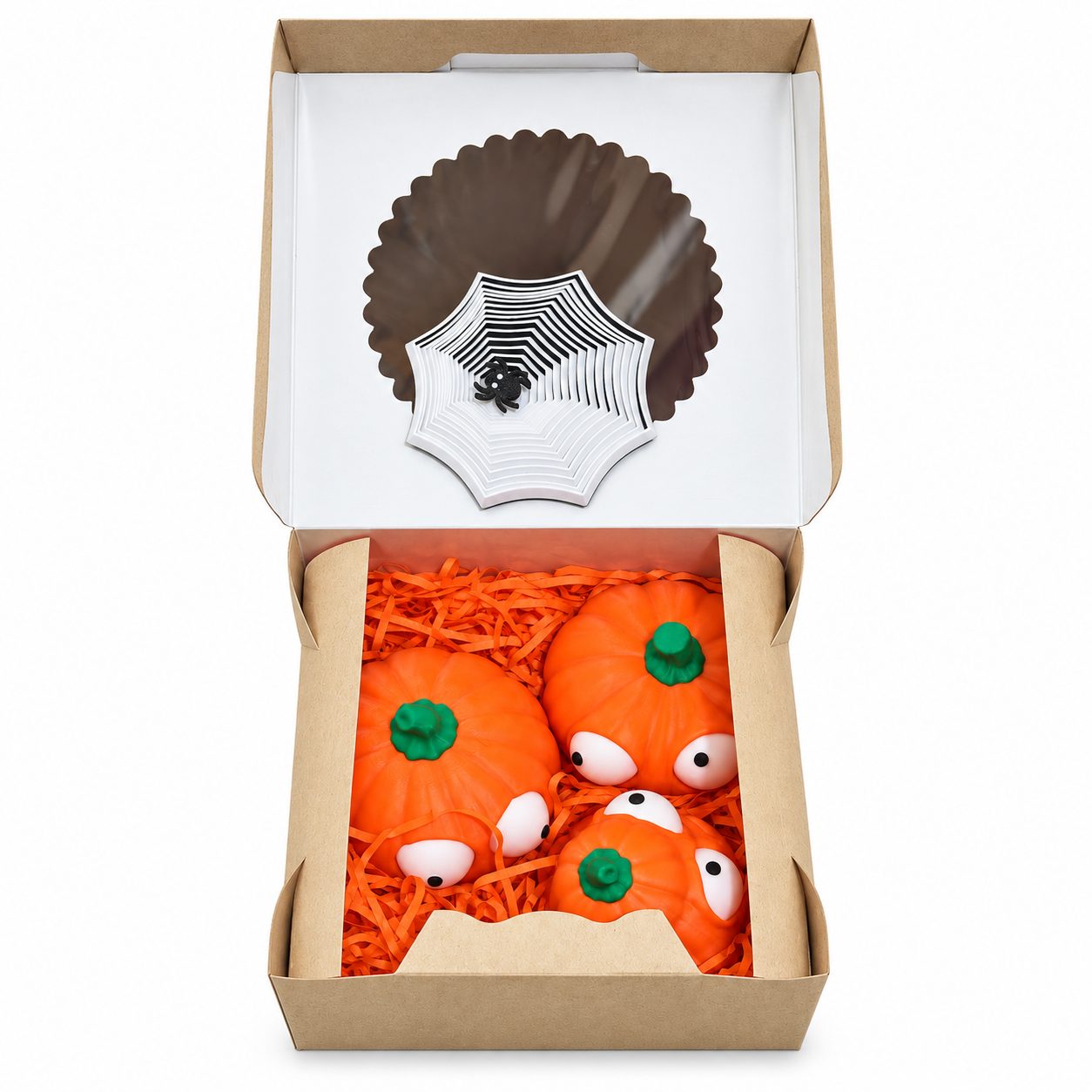 Kraft gift box with spiderweb decoration and pumpkin figures in orange shredded paper