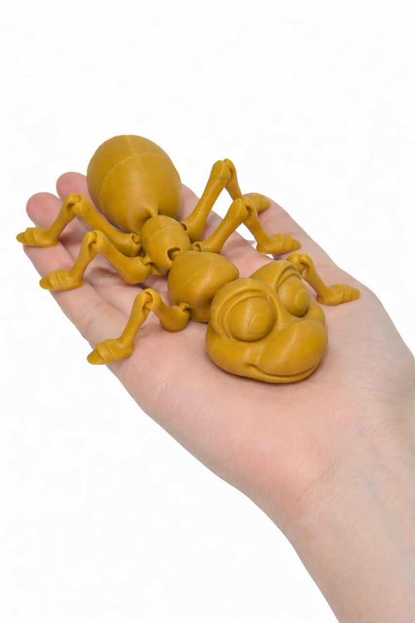 Articulated ant figure resting on a hand