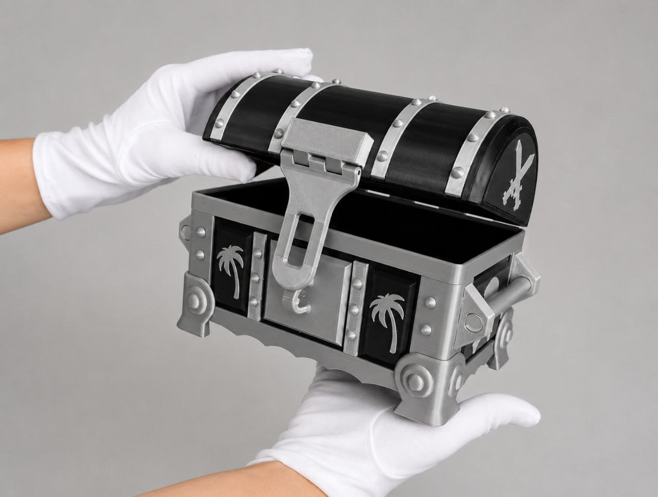 Printed treasure chest held in white gloves